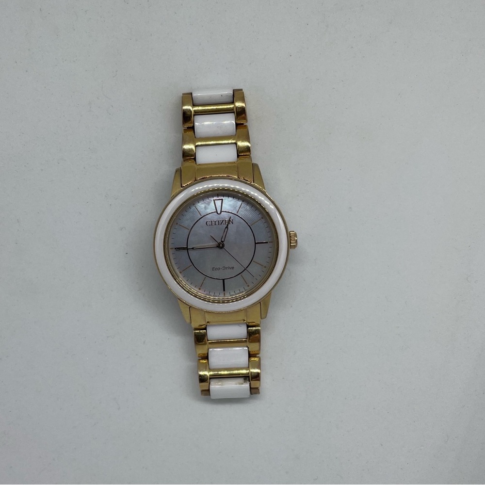 CITIZEN Eco-Drive Women's Gold & White Watch with Pearlized Face.